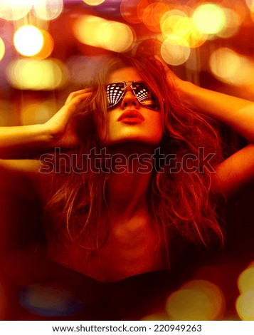 dark color toned picture of fashionable woman in nightclub