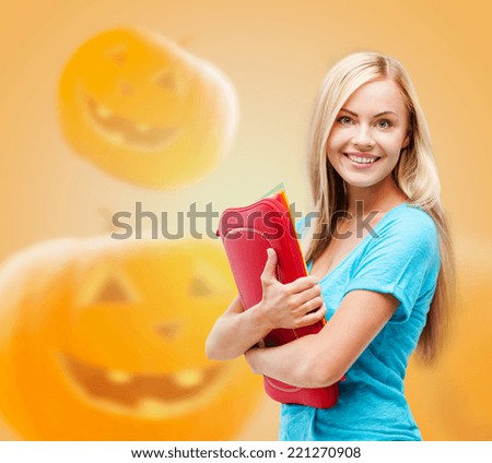 education, holidays, school and people concept - smiling student girl with books and tablet pc computer bag over halloween pumpkins background