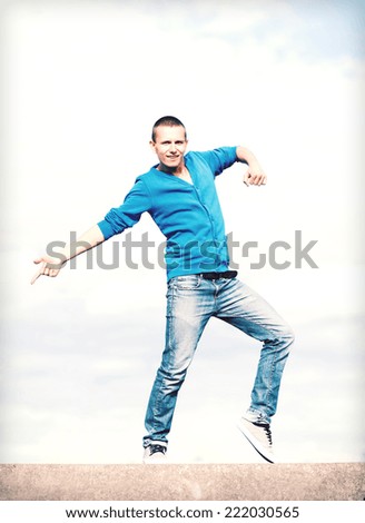 sport, dancing and urban culture concept - handsome boy making dance move