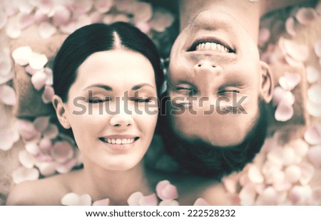 faces of couple in spa salon lying on the massage desks