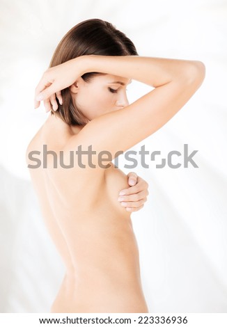 health, medicine, beauty concept - woman checking breast for signs of cancer