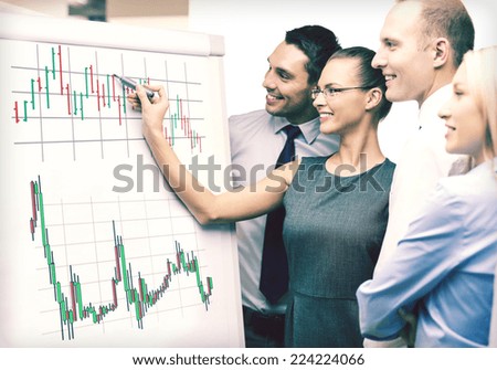 business, money and office concept - smiling business team with forex chart on flip board having discussion
