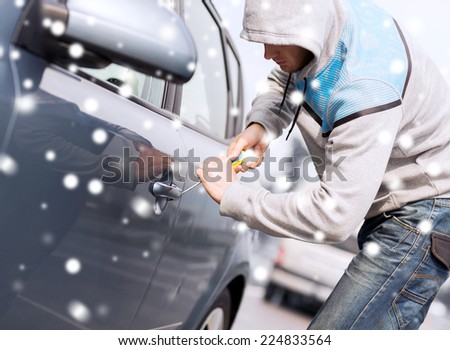 transportation, crime, people and burglary concept - thief breaking car lock screwdriver