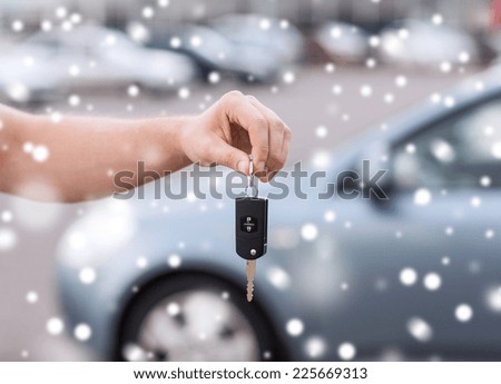 transportation, people, season and ownership concept - close up of man with car key outdoors