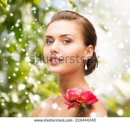 beauty, holidays, people and jewelry - woman with diamond earrings, ring and flower