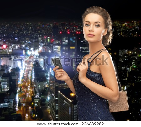 party, celebration, holiday and banking concept - beautiful woman in evening dress with small bag and vip card