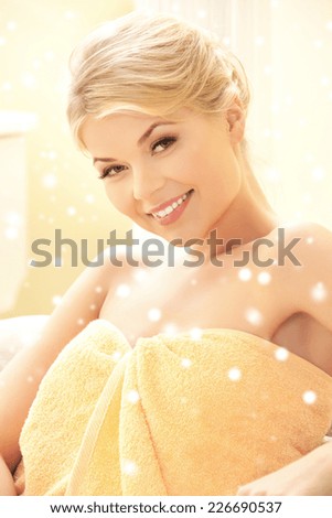 people, beauty, health and leisure concept - beautiful young woman in towel indoors