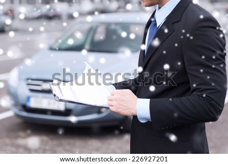 transportation, people, sale and ownership concept - close up of man with clipboard and car documents