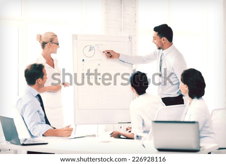 business concept - business team working with flipchart in office