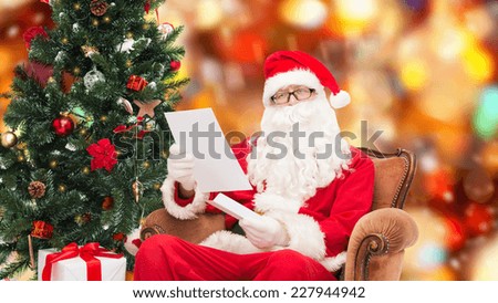 christmas, holidays and people concept - man in costume of santa claus with letter over red lights background