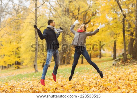 love, relationship, family and people concept - smiling couple having fun in autumn park