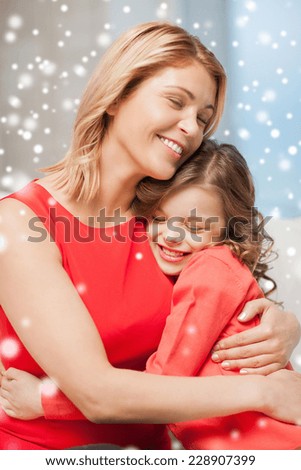 people, motherhood, family, winter and adoption concept - happy mother and daughter hugging at home