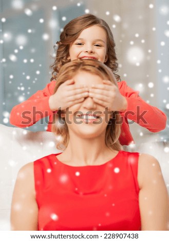 people, motherhood, family, winter and adoption concept - happy mother and daughter playing and having fun at home