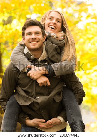 love, friendship, family and people concept - smiling friends having fun in autumn park