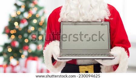christmas, advertisement, technology, and people concept - close up of santa claus with laptop computer over living room with tree