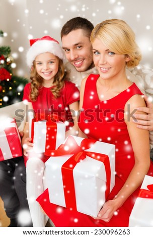 christmas, holidays, happiness and people concept - smiling family in santa helper hats with many gift boxes at home