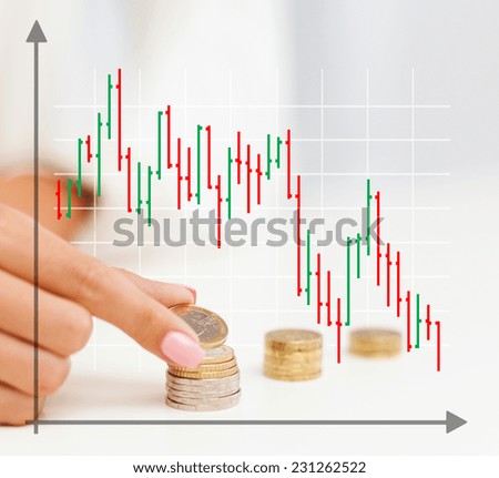business, finances, crisis, people and money saving concept - close up of graph and female hand putting euro coins into columns in office