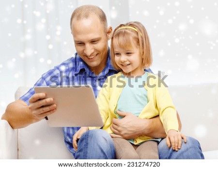 family, children, technology and people concept - happy father and daughter with tablet pc computer at home
