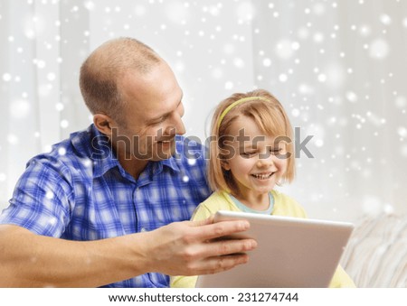 family, children, technology and people concept - happy father and daughter with tablet pc computer at home