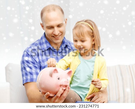family, children, money, investments and happy people concept - happy father and daughter with big pink piggy bank