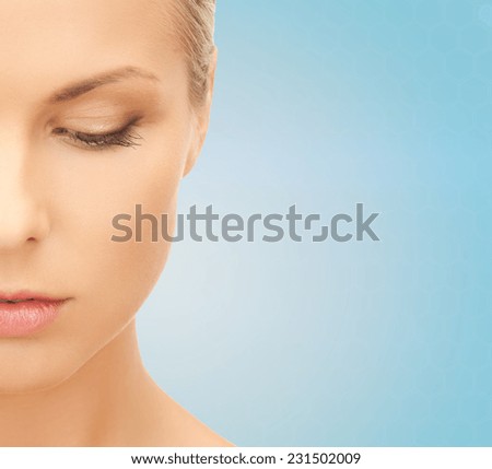 people and beauty concept - beautiful young woman over blue background