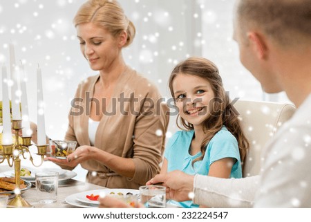 family, holidays, christmas and people concept - smiling family having dinner at home
