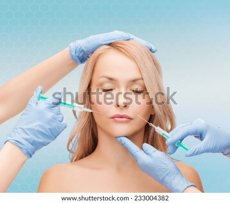 beauty, people and plastic surgery concept - woman face and beautician hands with syringes