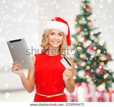 holidays, technology and people concept - smiling woman in santa helper hat with tablet pc computer over living room and christmas tree background