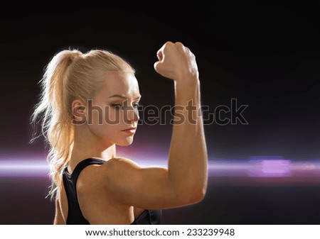 fitness and diet concept - close up of beautiful athletic woman flexing her biceps