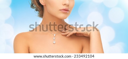 wedding, bridal, jewelry and luxury concept - beautiful woman wearing shiny diamond necklace