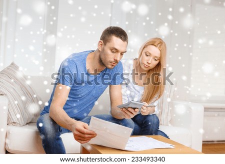 tax, finances, family, home and people concept - busy couple with papers and calculator at home