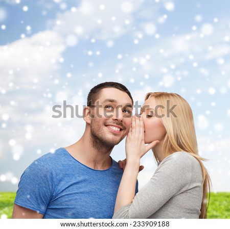 relationships, love, people, information and couple concept - smiling girlfriend telling boyfriend secret over blue sky with snow and grass background