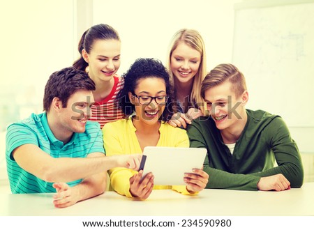 education, technology and college concept - five smiling students with tablet pc computer at school