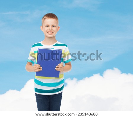 education, childhood and school concept - smiling little student boy with blue book over blue sky background