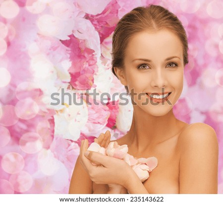 beauty, people and health concept - beautiful smiling young woman with flowers and bare shoulders over pink floral background