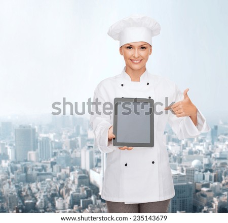 cooking, technology and food concept - smiling female chef, cook or baker with tablet pc computer pointing finger to blank screen over city background