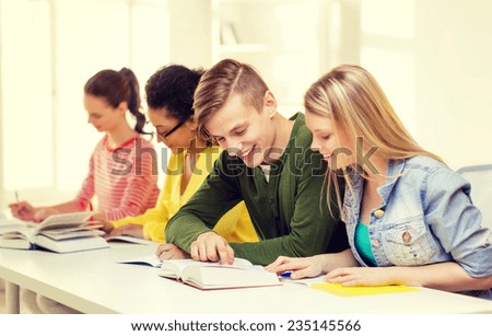 education and school concept - five smiling students with textbooks and books at school