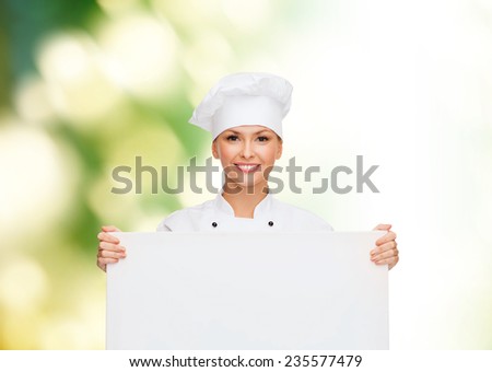 cooking, advertisement and people concept - smiling female chef, cook or baker with white blank board over green background