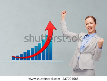 business, success, triumph and people concept - young happy businesswoman with hands up over gray background and growth chart