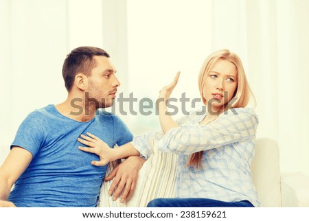 love, family and happiness concept - unhappy couple having argument at home