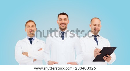healthcare, profession and medicine concept - group of smiling male doctors in white coats with clipboard and stethoscope over blue background