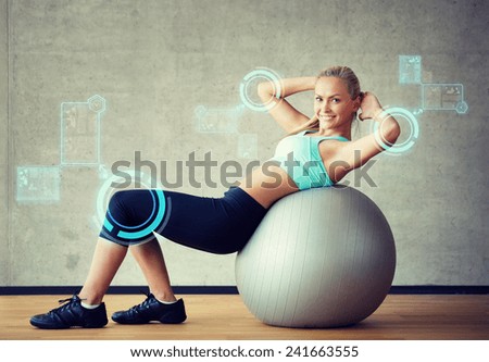 fitness, sport, training, future technology and lifestyle concept - smiling woman with exercise ball in gym over virtual screen projections