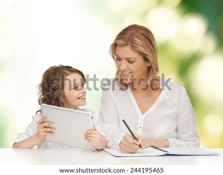 people, family, home education, children and technology concept - happy mother and daughter with tablet pc and notebook over green background