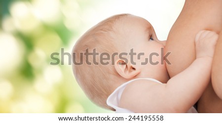 motherhood, children, people and care concept - close up of mother breast feeding adorable baby over green background