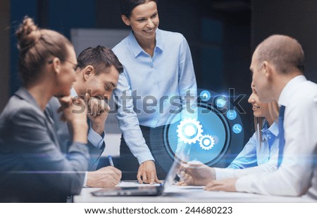 business, technology, deadline, management and people concept - smiling female boss talking to business team in office late night