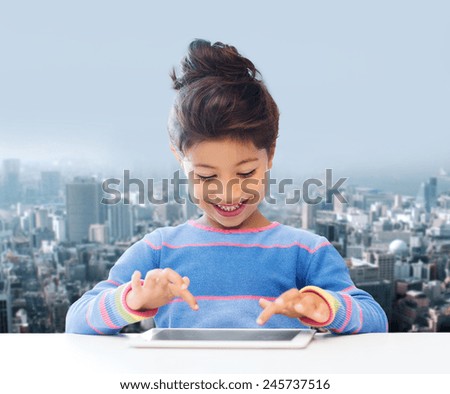 education, children, technology and people concept - happy little girl with tablet pc computer over city background