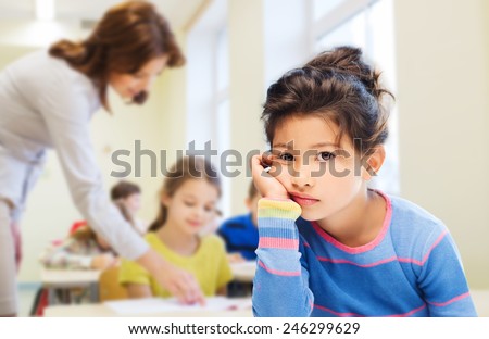 education, elementary school, people, childhood and emotions concept - sad or bored little student girl over green chalk board background