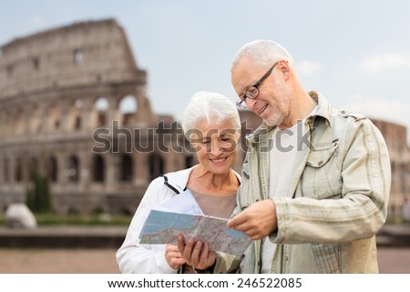 family, age, tourism, travel and people concept - senior couple with map and city guide on street over coliseum background