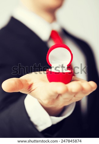 man making proposal with wedding ring and gift box.