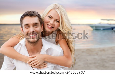 summer holiday, vacation, dating and travel concept - happy couple having fun over tropical beach background